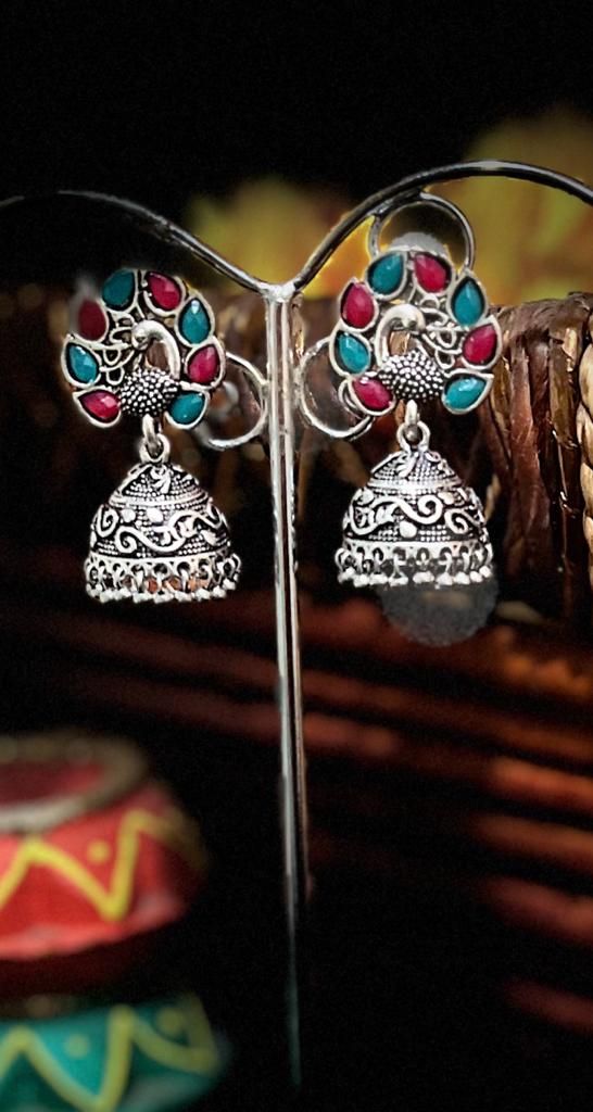 Beautiful Peacock with Open Feathers embedded with Pink and Green Meena Silver replica Jhumka