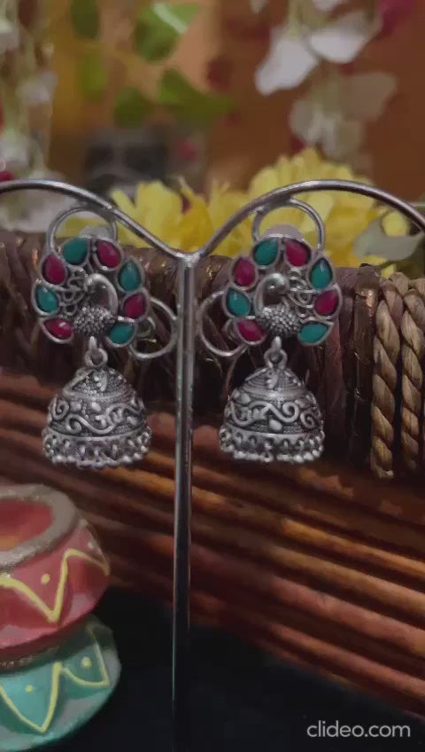 Beautiful Peacock with Open Feathers embedded with Pink and Green Meena Silver replica Jhumka